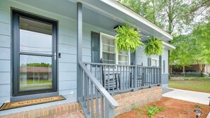 A house with a front porch, a door, and a brick foundation. - Cozy Mullins Retreat w/ Backyard & Covered Porch! (Mullins)