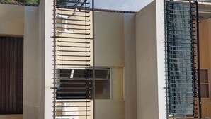 A building with a balcony, a window, and a door.