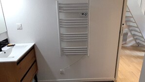 A small bathroom with a white sink, a mirror, and a towel rack. - Beachfront Villa with WiFi, Terrace & Parking - Sleeps 4 (Capbreton)