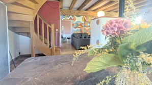 Eine Treppe führt zu einem Wohnzimmer mit einer Couch und einer Wand mit Muster.