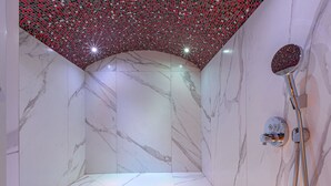 A modern bathroom with a shower, marble walls, and a mosaic ceiling. - Luxury Duplex in Val-d'Isère with Jacuzzi and Hammam (Val-d'Isère)