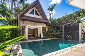 A villa with a swimming pool, surrounded by lush greenery and a thatched-roof structure. - Villa Novaku, Bali — An escape from the hustle and bustle of downtown Seminyak! (Kecamatan Kuta)