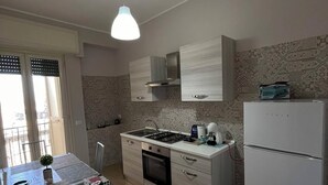 Une cuisine moderne dotée d’un îlot central, d’un four encastré et d’un réfrigérateur à deux portes.