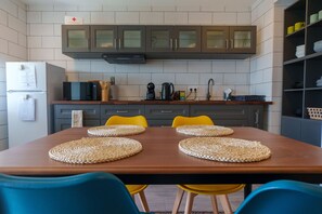 Fridge, microwave, cookware/dishes/utensils, dining tables