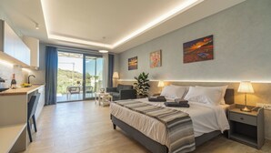 A modern hotel room with a bed, bedside tables, a desk, and a balcony with a view. - Amour Relax Hotel (Apokoronas)