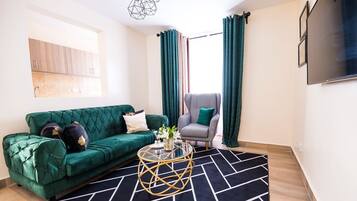 Deluxe Apartment | Living area | 24-inch Smart TV with digital channels