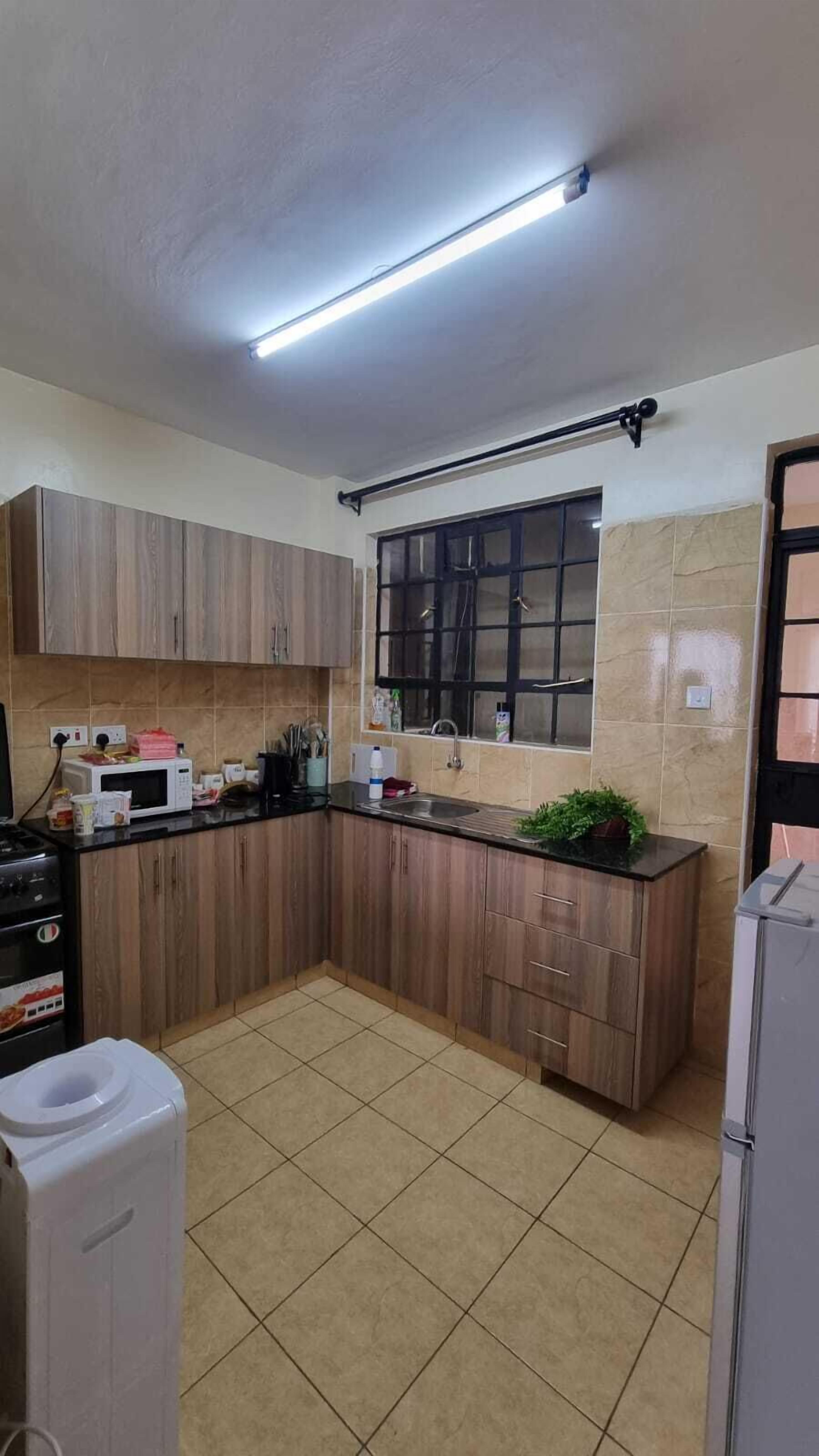 Family Apartment | Private kitchen | Fridge, microwave, cookware/dishes/utensils, dining tables
