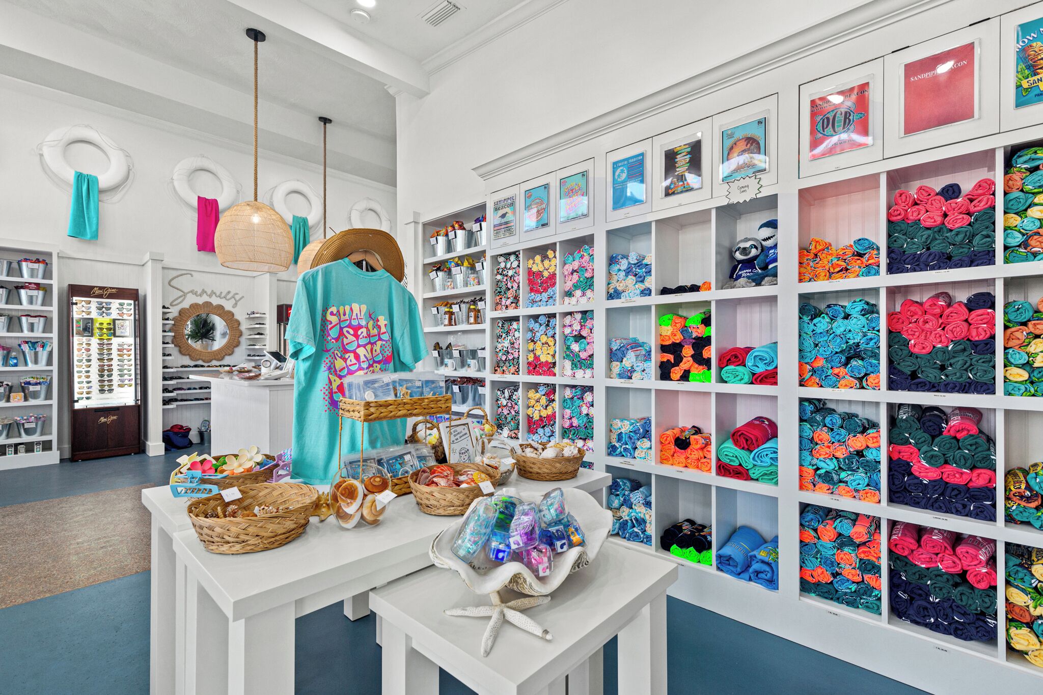 A brightly lit store with shelves of colorful merchandise and a display table with various items.