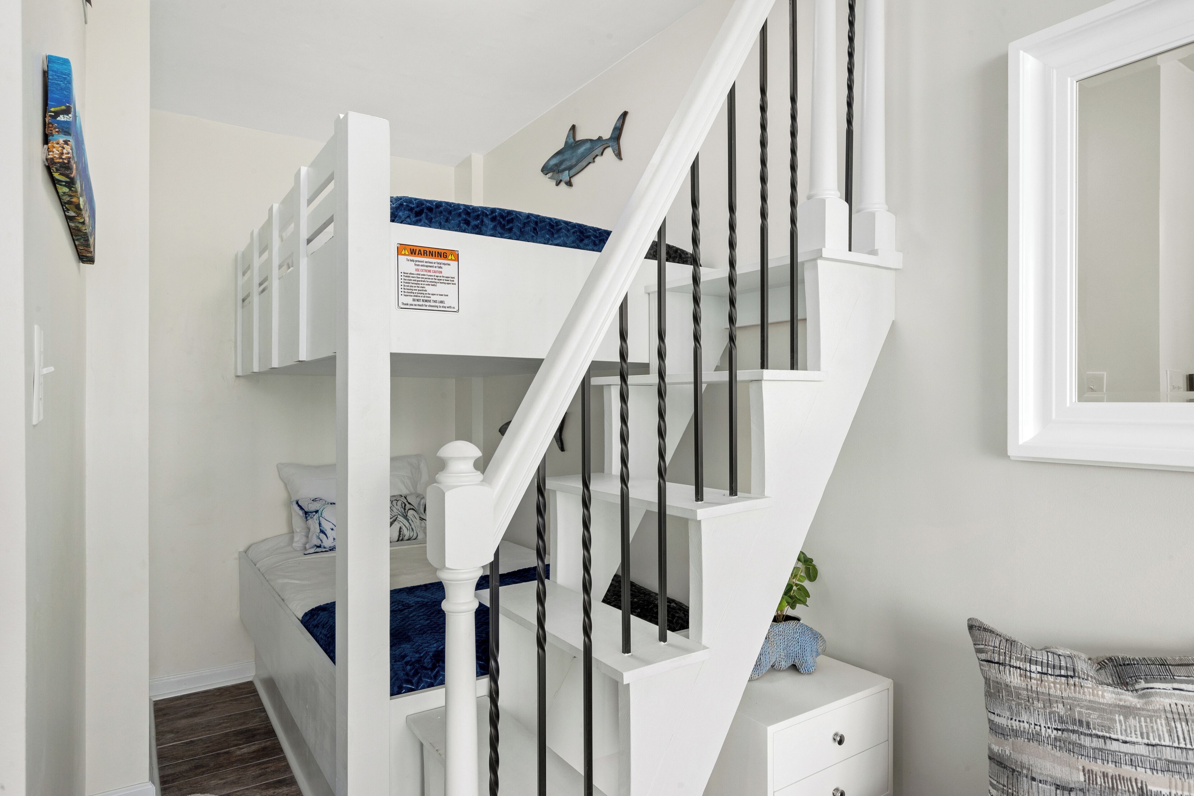 A staircase with white railings and a blue accent wall.