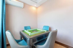 A compact room with a small table and two chairs.