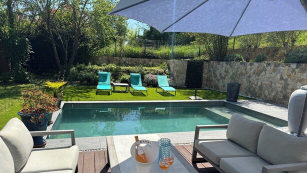 A pool area with a table, chairs, and a bottle of champagne. - Villa Saint-paul-de-vence With Swimming Pool (Saint-Paul-de-Vence)