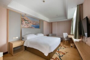 A hotel room with a bed, bedside table, chair, desk, television, and a painting on the wall. - Vienna 3 Best Hotel (Shanghai Qiantan Expo Sanlin) (Shanghai)