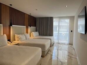 A hotel room with two beds, a large mirror, and a view of the city. - Hotels 111 (San Andrés)