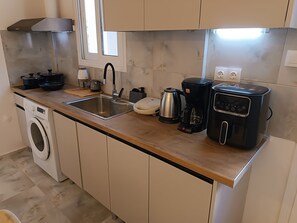 Een koelkast, een oven, een kookplaat, een koffiezetapparaat/waterkoker