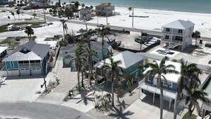 An aerial view of a coastal area with buildings, a beach, and a road. - Oceanview 3-bdrm home steps from beach!  Heated pool & hot tub.  Sleeps 6. (Fort Myers Beach)