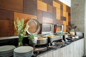 A buffet setup with various food containers and a sign indicating 'Breakfast Buffet.' - Swiss-Belcourt Sunset (Bali)