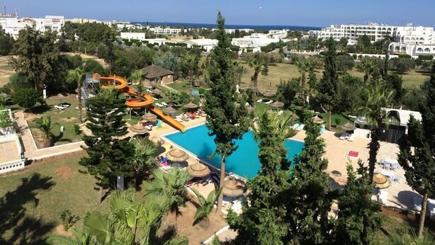 A resort with a swimming pool, a water slide, and a beach area. - Miramar Sharm ElKantaoui (Port El Kantaoui)