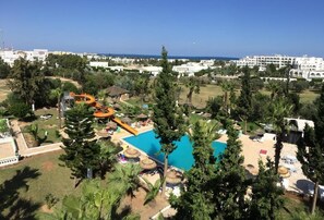 A resort with a swimming pool, a water slide, and a beach area. - Miramar Sharm ElKantaoui (Port El Kantaoui)