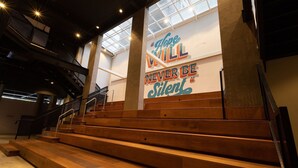 A staircase with a motivational quote on the wall and a view of the interior space. - Town.Co Housi by My Way (Porto Alegre)