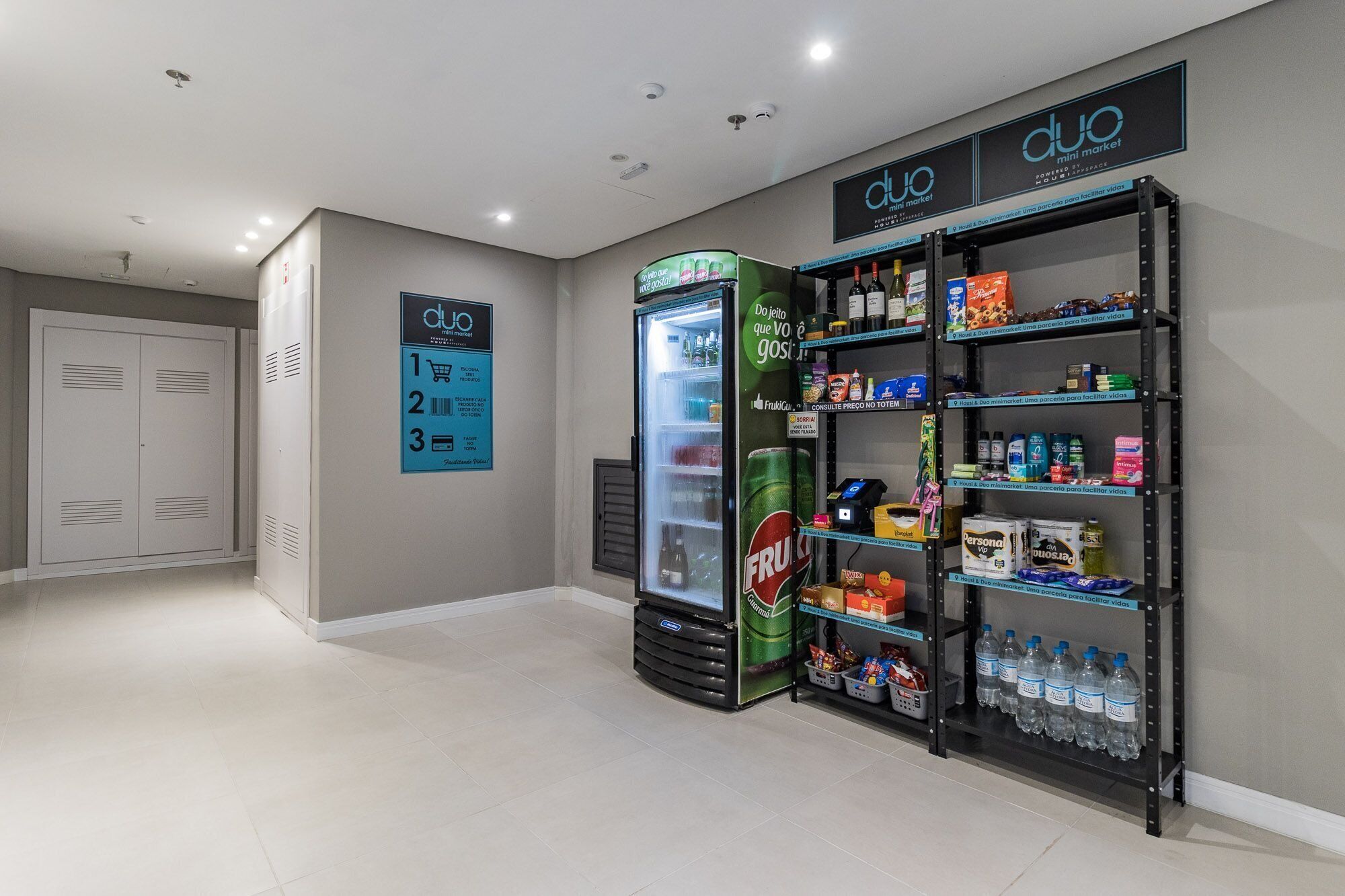 A clean, modern retail space with a refrigerated display and shelves stocked with various products.
