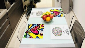 A modern kitchen with a dining table, a refrigerator, and a potted plant. - Charming apartment with 3 bedrooms and WiFi, AC in marvelous Catania (Catania)