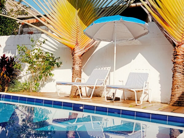 Outdoor pool, open 8:00 AM to 8:00 PM, pool umbrellas, pool loungers