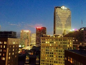 A cityscape with high-rise buildings, including a prominent hotel with a lit sign.