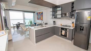 A modern kitchen with a built-in stove, microwave, and refrigerator.