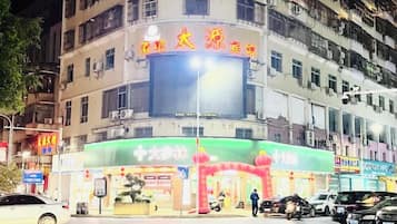 A multi-story building with a large illuminated sign at the top.