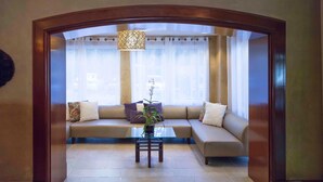 A living room with a sofa, a glass coffee table, and a potted plant. - Chic Condo near CocoWalk & Coral Gables (Miami)
