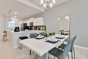 A modern kitchen with white cabinetry, a stainless steel refrigerator, and a built-in microwave. - Last Minute Disney Getaway! Luxury Condo with Private Balcony. Book Now! #65757 (Orlando)