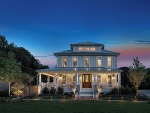 A two-story house with a front porch, large windows, and a well-maintained lawn. - 1313 West Luxury Boutique Hotel (Annapolis)