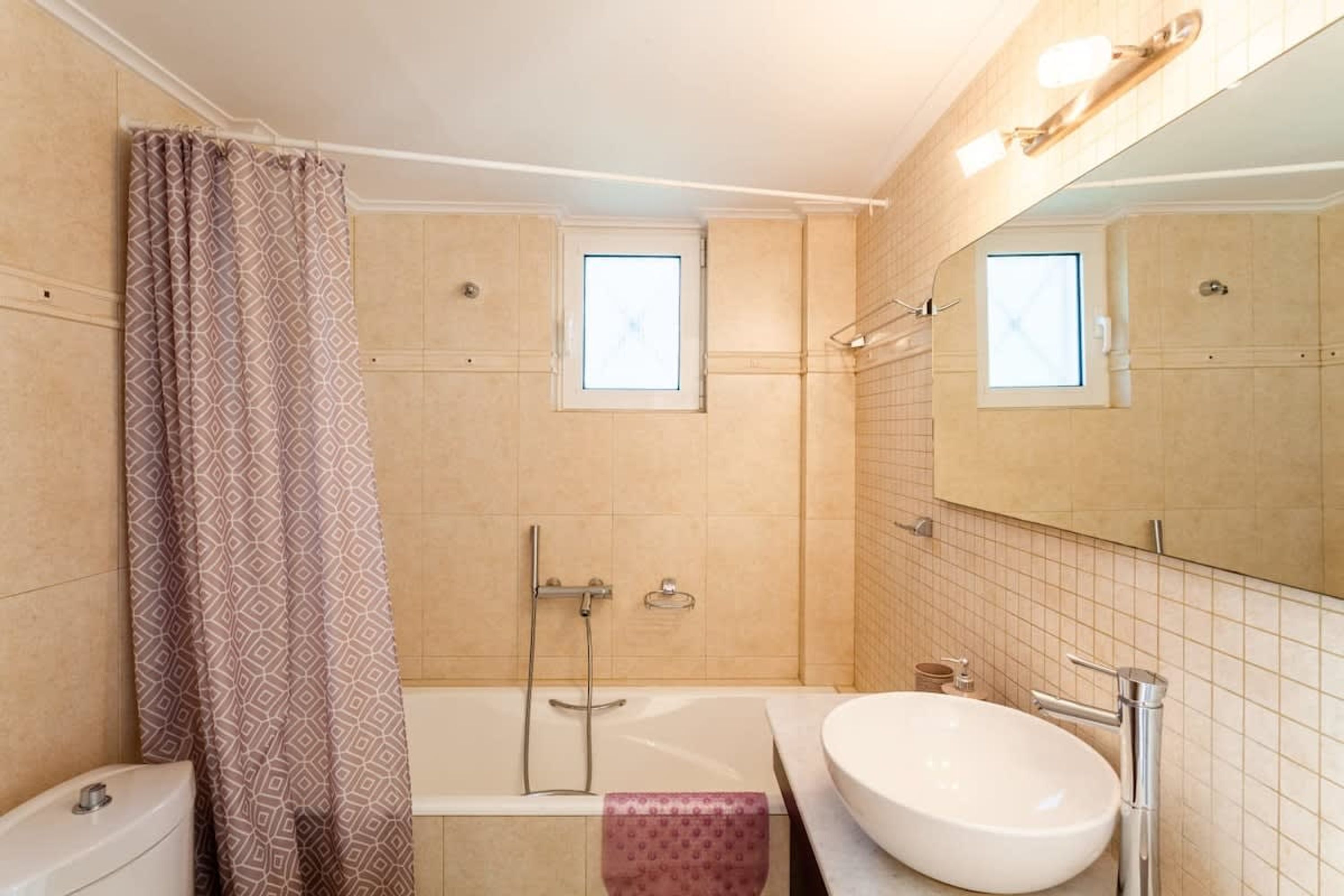 A bathroom with a bathtub, a sink, and a shower.
