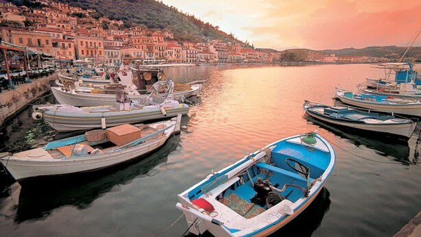 A harbor with boats docked, a waterfront promenade, and buildings along the shore. - Mani s Aura Seaside-spacious Summer Retreat (West Mani)