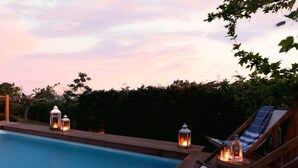 A poolside area with lounge chairs and lanterns. - Navarino Captains Villa - Lux Private Pool Retreat (Trifylia)
