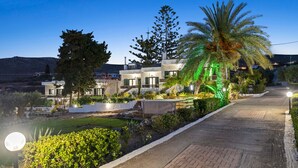 A modern hotel with a paved driveway, well-maintained gardens, and a clear view of the surrounding landscape. - Seaside Charm Near Heraklion Villa Maro II Getaway (Hersonissos)