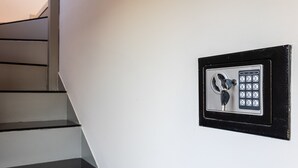 A security keypad on a white wall next to a staircase. - Ventiri Lofts - Luxury Duplex w Private Garden (Kalamata)