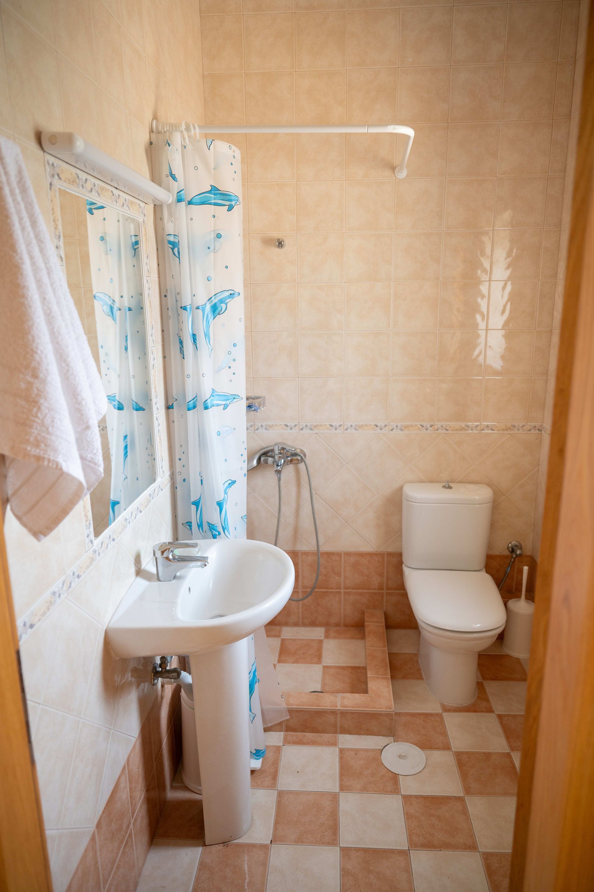 A bathroom with a sink, toilet, and shower.