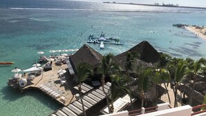A resort with a pool area, lounge chairs, and a dock.
