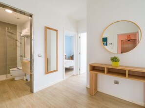 A modern bathroom with a glass shower enclosure, a wooden vanity, and a large mirror. - VIVENTE 3A BY CANARIAS GETAWAY (Las Palmas de Gran Canaria)
