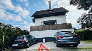 A modern two-story house with a car parked in front. - Cocooning apartment 50 m2, terrace 40 m2 (Thonon-les-Bains)