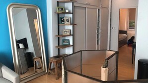 A modern bedroom with a large mirror, built-in wardrobe, and a glass table. - Loft 2 BR Loft Effeil tower AC by LCC Agency (Paris)