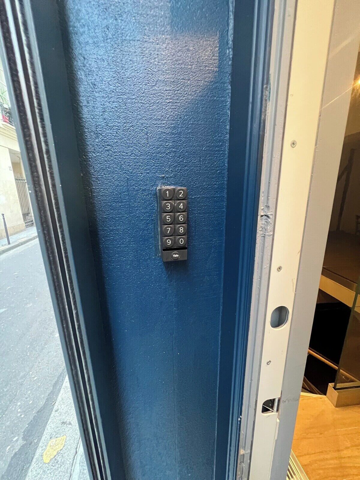 A blue door with a Yale lockset.