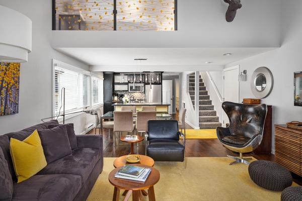 Comfortable living room sitting area with high ceilings and gas fireplace