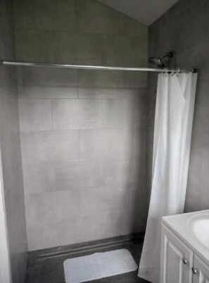 Shower, hair dryer, towels, toilet paper