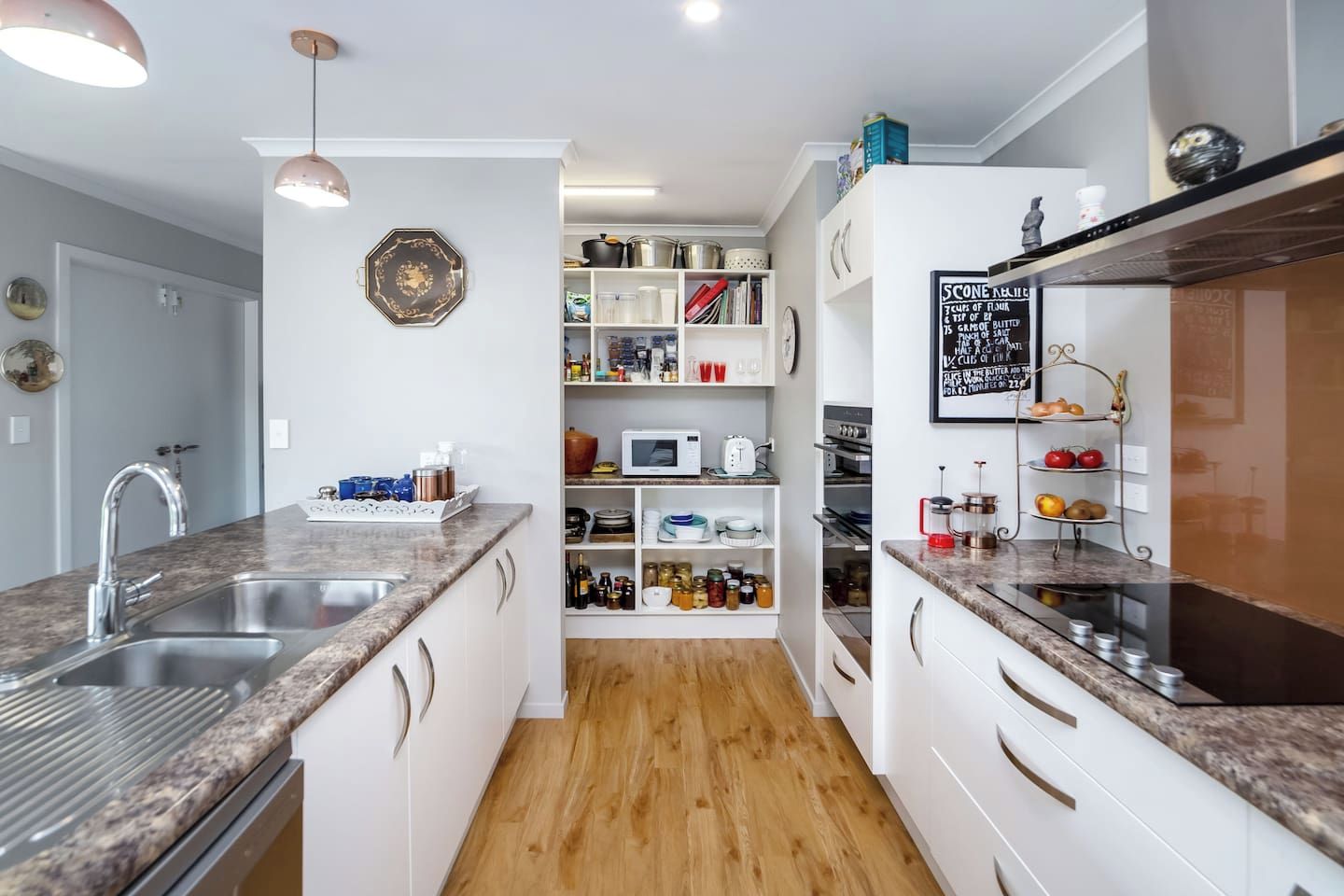 A modern kitchen with granite countertops, stainless steel appliances, and a central island.