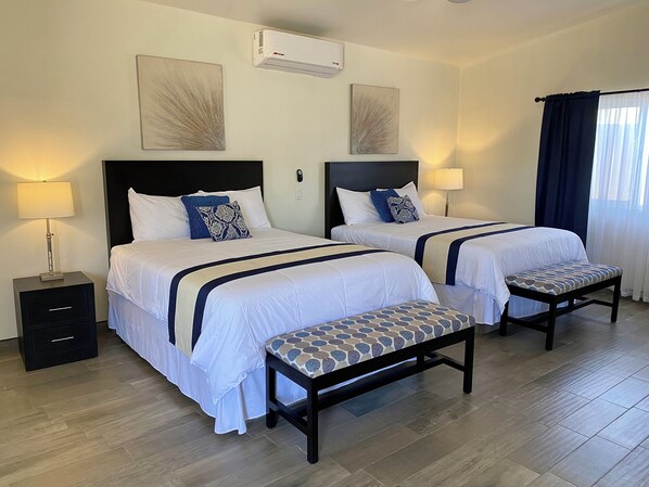 Deluxe Quadruple Room | Minibar, blackout curtains, iron/ironing board, free WiFi