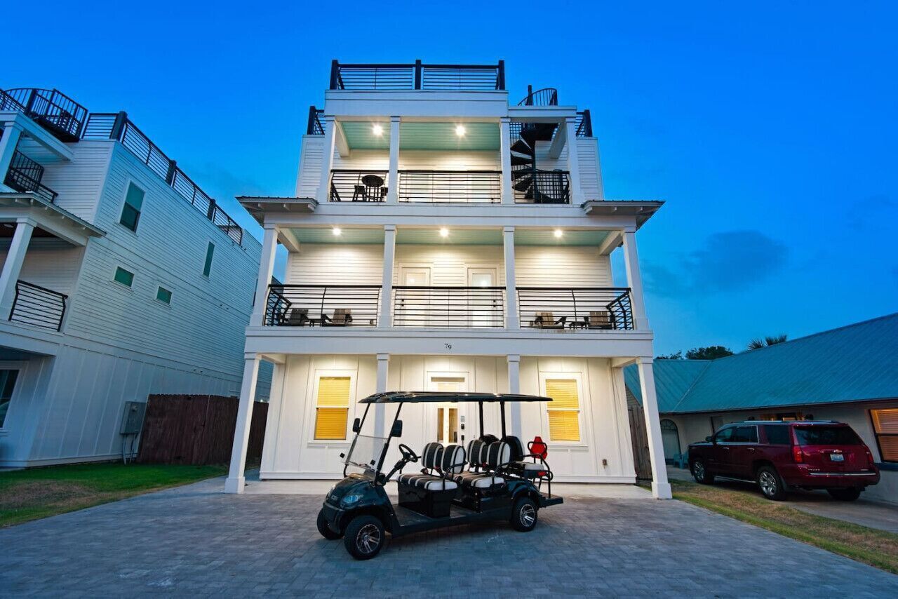A multi-story building with a golf cart parked in front.