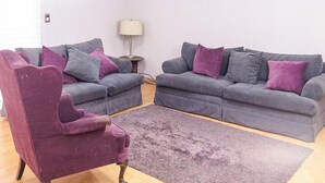 A living room with a grey sofa set, a purple armchair, and a small side table with a lamp. - New Cozy San Pedro Home Patio Work Area (San Pedro Garza García)