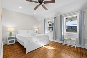A bedroom with a bed, bedside lamps, a ceiling fan, a window with curtains, and a radiator. - Orange Loop-walk to beach & bars. Beach block (Atlantic City)